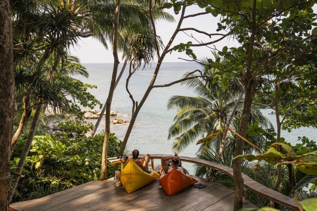 people sitting on deck looking over water view